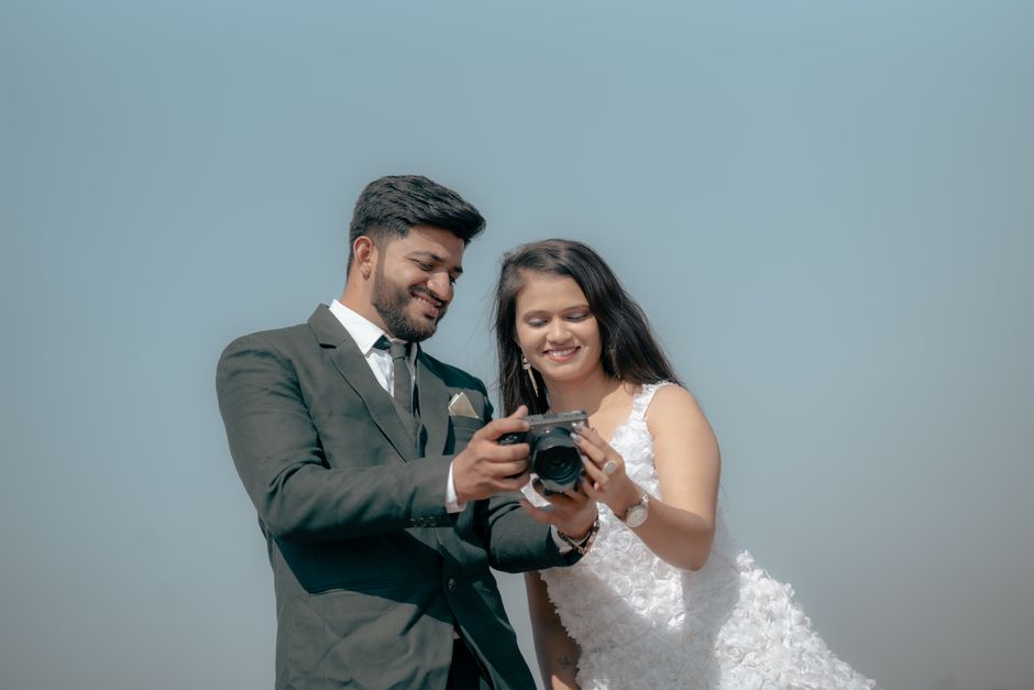 Smiling wedding photographer holding a professional camera